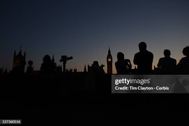 Tourists photograph sunset behind Big Ben and the Houses of parliament. Big Ben is to chime non-stop for three minutes to help ring in the London...