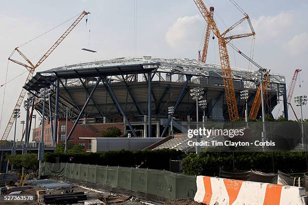 Lone racket rises amongst the construction site as tennis still takes place on the outer courts despite the massive construction operation at Arthur...