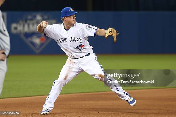 Matt Dominguez of the Toronto Blue Jays throws out the baserunner from third base in the eighth inning during MLB game action against the Chicago...