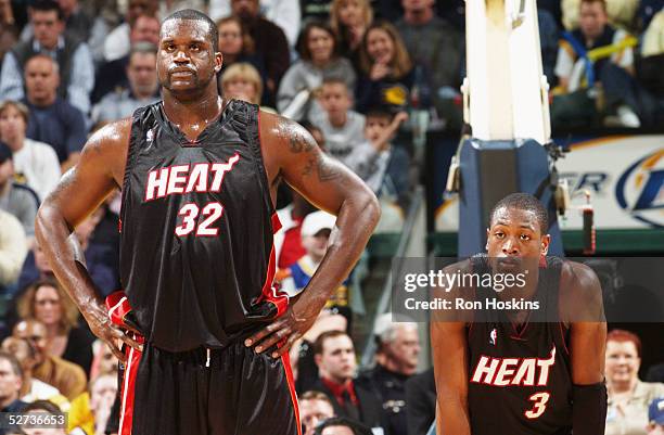 Shaquille O'Neal and Dwyane Wade of the Miami Heat rest against the Indiana Pacers during the game on March 31, 2005 at Conseco Fieldhouse in...