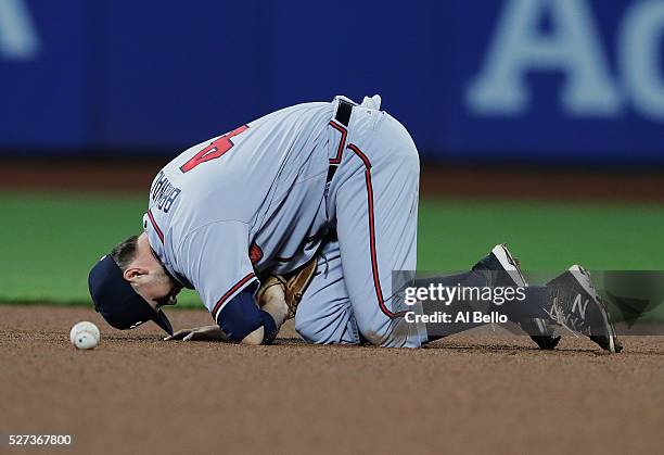 Reid Brignac of the Atlanta Braves reacts after being hit in the face by a ball hit bt David Wright of the New York Mets in the fourth inning during...