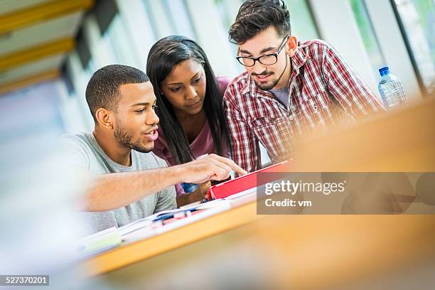 students studying in a library - male teen tablet bildbanksfoton och bilder