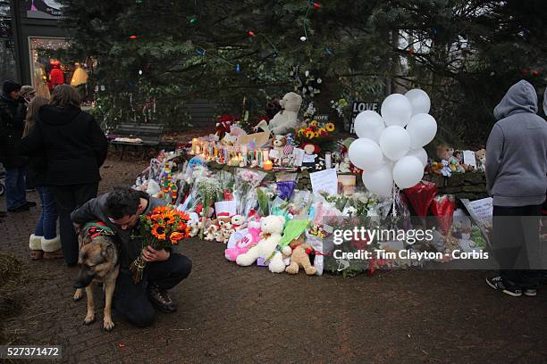 Mourners at the shrine set up around the towns Christmas tree in Sandy Hook after the mass shootings at Sandy Hook Elementary School, Newtown,...