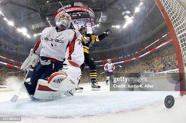 Braden Holtby of the Washington Capitals reacts after being scored on by Tom Kuhnhackl of the Pittsburgh Penguins in Game Three of the Eastern...