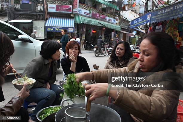 Locals cook food on a street corner of the old quarter of Hanoi, Vietnam. Hanoi is the capital of Vietnam and the country's second largest city....
