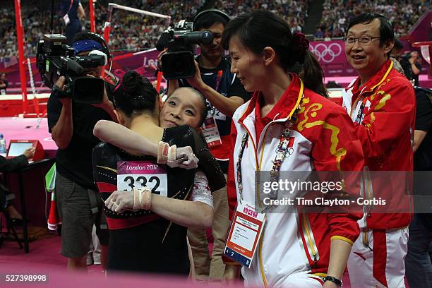 Kexin He, China, is congratulated by team mate Jinnan Yao after winning the Silver Medal in the Gymnastics Artistic, Women's Apparatus, Uneven Bars...