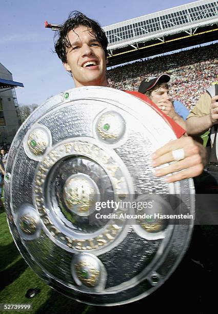 Michael Ballack of Bayern Munich is presented a mock German soccer championship after the Bundesliga match between 1. FC Kaiserslautern and FC Bayern...