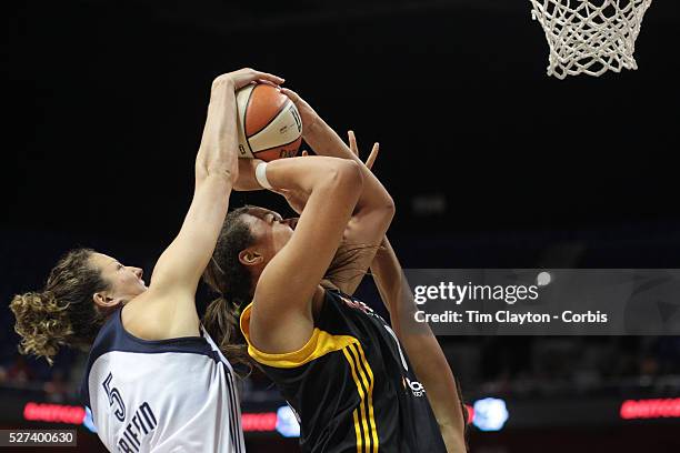 Elizabeth Cambage, Tulsa Shock, is blocked by Kelsey Griffin, , and Mistie Bass, Connecticut Sun, during the Connecticut Sun V Tulsa Shock WNBA...