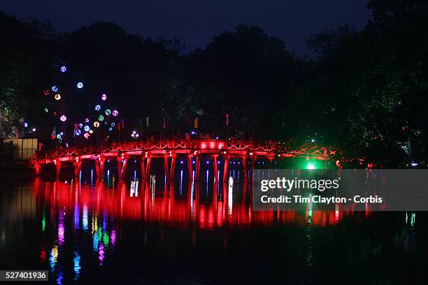 Man exercises early in the morning on the wooden red-painted Huc Bridge, also know as the Morning Sunlight Bridge and The Red Bridge which connects...