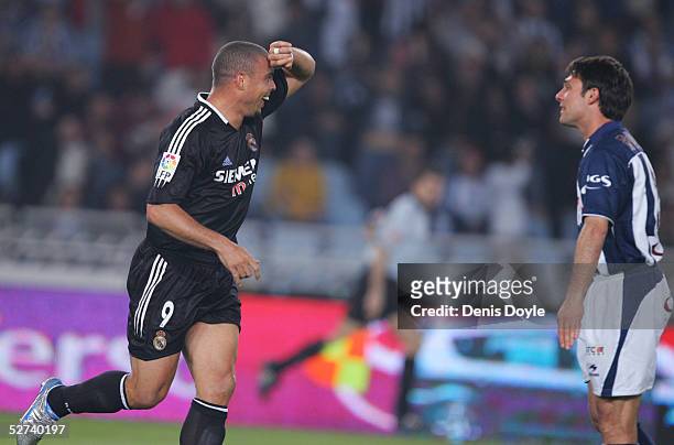 Real Madrid's Ronaldo celebrates scoring a goal beside Real Sociedad's Adriano Rossato during a La Liga match between Real Sociedad and Real Madrid...