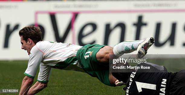 Mathias Hain of Bielefeld fouls Miroslav Klose of Bremen during the Bundesliga match between Werder Bremen and Arminia Bielefeld at the Weser Stadium...