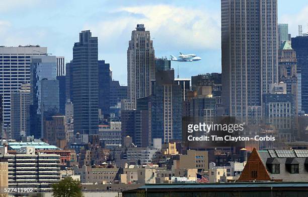 The NASA space shuttle Enterprise, riding on top of a modified jumbo jet, flying at low altitude past Manhattan during it's flypast of New York City....