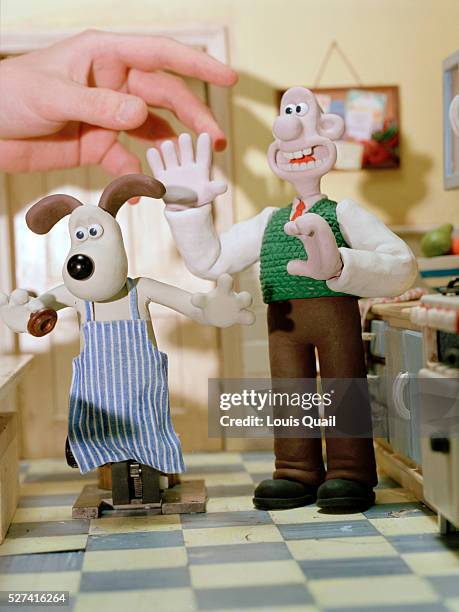 Wallace and Gromit on the 'Breakfast Set' with the hand of an animator. Nick Park's sets recreate the world of Wallace and Gromit in painstaking...