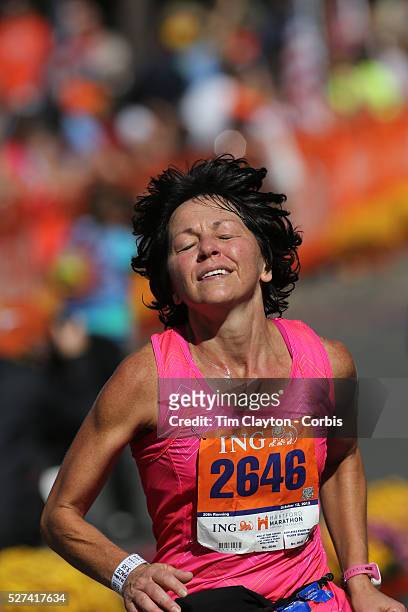 The Finish Line. Expressions of agony and ecstasy on the faces of athletes as Debra Long, Winfield, finishes the ING Hartford Marathon, Bushnell...