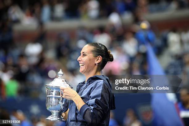 Flavia Pennetta, Italy, shows the trophy to Italian Prime Minister Matteo Renzi after her victory over Roberta Vinci, Italy, in the Women's Singles...