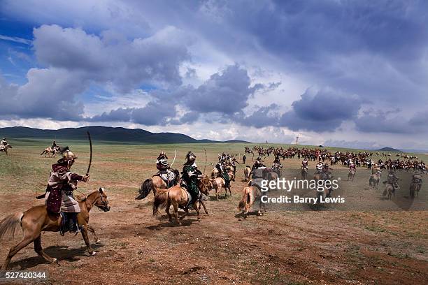 Sword wielding cavalry charge. Genghis Khan's 800th anniversary Festival of Eurasia. A re-enactment of the unification of the Mongolian tribes under...