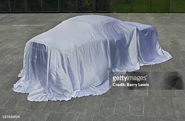 Top of the range luxury car covered before being displayed outside an art gallery in Cork for a promotional sales event.