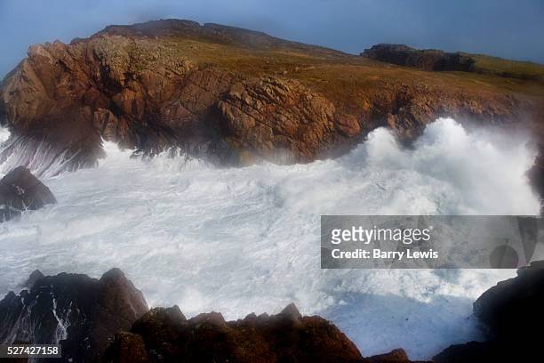 The full force of the Atlantic with 11 meter wave hitting the 100ft cliffs behind West Town. Tory Island - nine miles off the Donegal coast,...
