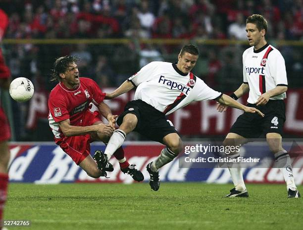 John van Buskirk of Erfurt is tackled by Markus Husterer of Frankfurt while Torben Hoffmann of Frankfurt stands nearby during the match of the Second...