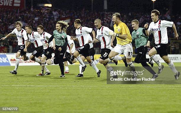 Members of the Frankfurt team celebrate their victory by diving on the pitch after the Second Bundesliga match between RW Erfurt and Eintracht...