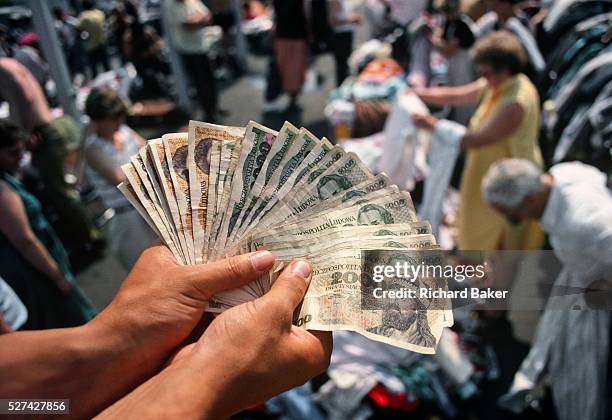 Spread of old Polish Zloty bank notes are spread out in the hands of a private market trader in Central Warsaw. We can see a dozen or so notes of...