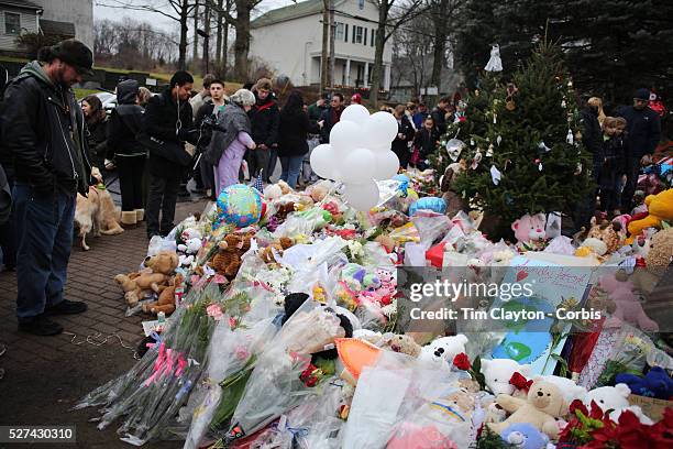 Tributes to the victims left at the shrine set up around the towns Christmas tree in Sandy Hook after the mass shootings at Sandy Hook Elementary...