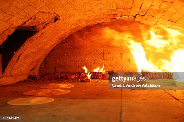 Matza bread baking in a traditional brick oven for Passover, the oven is situated in a small room out the back of Bethune Road synagogue. The baking...