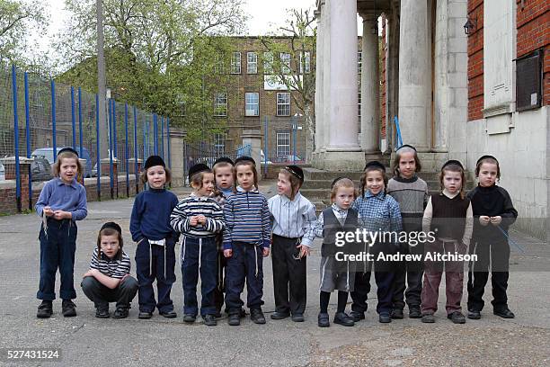 Orthodox Jewish school boys from the Bobov school watching the Lag B'omer bonfire in the school playground. Lag B'omer is the holiday celebrating the...