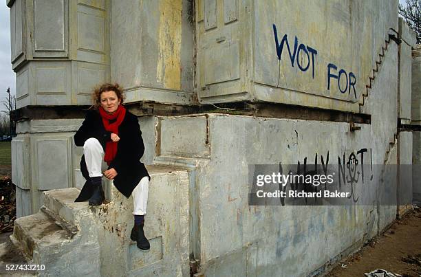 The artist Rachel Whiteread CBE sits on the steps of her best-known sculpture called 'House'. 'House' stands alone on a now-empty and house-less East...