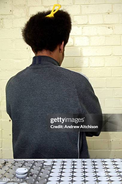 Prisoner in the printing workshop prepares key tags to be sent off to other prisons. HMP Coldingley, Surrey was built in 1969 and is a Category C...