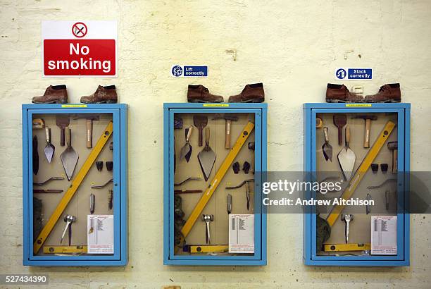 Toolboxes sit on the wall in the building workshop of Wandsworth prison. Each tool is shadowed so that any missing tools can be spotted straight...