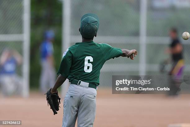 An outfielder throws the ball in during the Norwalk Little League baseball competition at Broad River Fields, Norwalk, Connecticut. USA. Photo Tim...