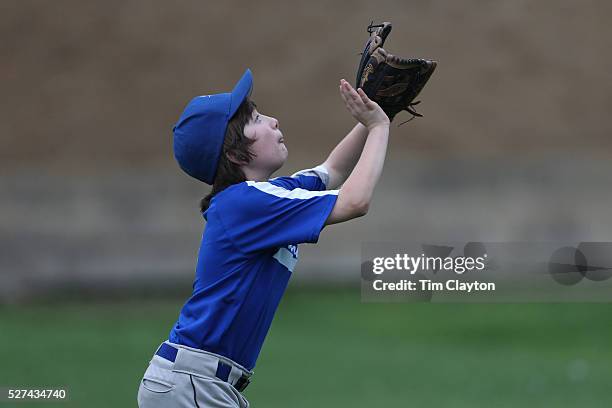 Young baseball player makes a catch in the outfield during the Norwalk Little League baseball competition at Broad River Fields, Norwalk,...