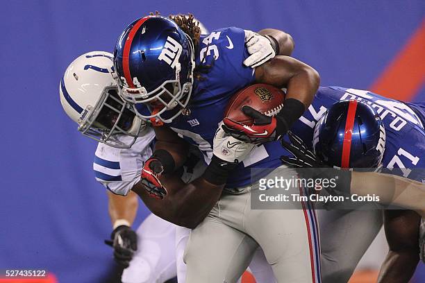 Laron Scott, New York Giants, is tackled during the New York Giants V Indianapolis Colts, NFL American Football Pre Season match at MetLife Stadium,...