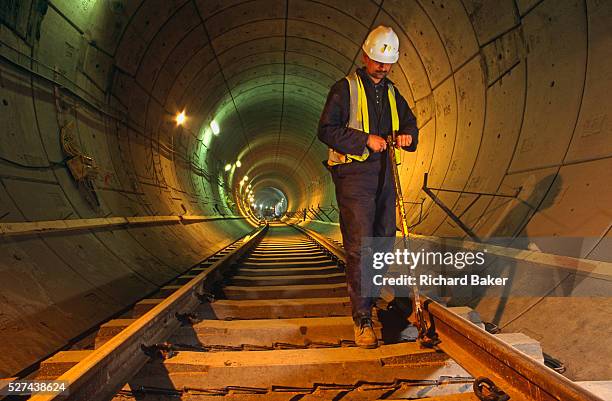 An engineer working underground during construction of the Heathrow Express train project on behalf of Heathrow airport operator BAA , London...