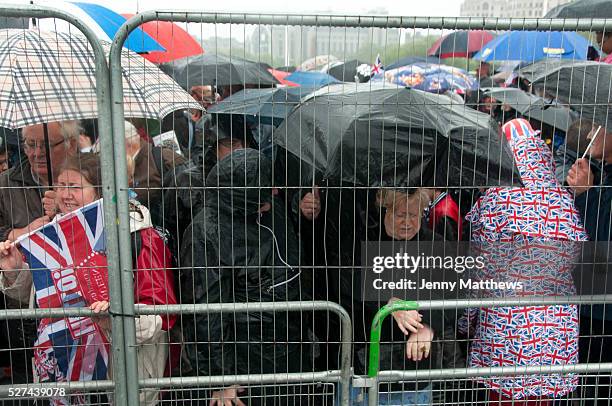 Queen Elizabeth Diamond Jubilee celebrations. Spectators had to watch behind wire fence in pouring rain