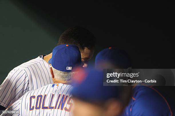 Wilmer Flores, New York Mets, with Manager Terry Collins in the dugout after learning he had been traded to the Milwaukee Brewers during game. The...