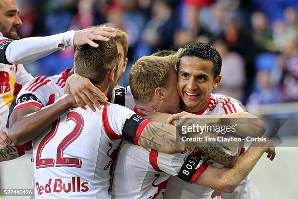 Tim Cahill, , New York Red Bulls, celebrates a goal by Dax McCarty , along with team mate Jonny Steele and Roy Miller, , during the New York Red...