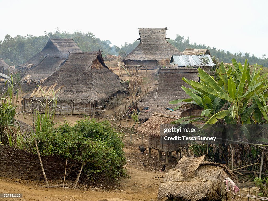 Lao PDR - Rural life - An Akha village with traditional grass roofed houses in remote Phongsaly prov