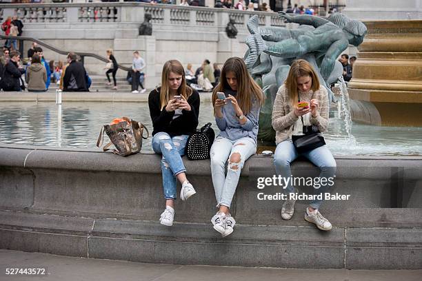 Three teenage girls are lost in the world of smartphone apps and messaging, in Trafalgar Square. While in a very busy environment, the capital's main...