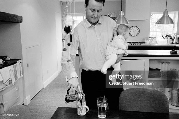 David Cameron, Conservative Party Leader and Conservative MP for Whitney, Oxfordshire, UK pours coffee at home with his youngest child Arthur