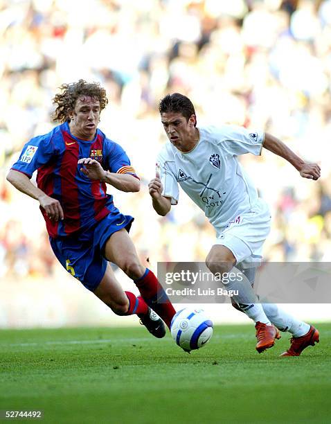 Carles Puyol of FC Barcelona challenges Francisco of Albacete during the La Liga match between FC Barcelona and Albacete on May 1, 2005 at Nou Camp...