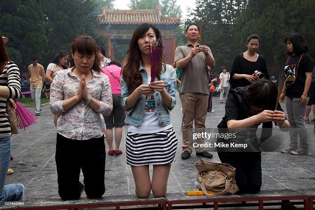 China - Beijing - People come to pray and burn incense sticks at The Yonghe Temple