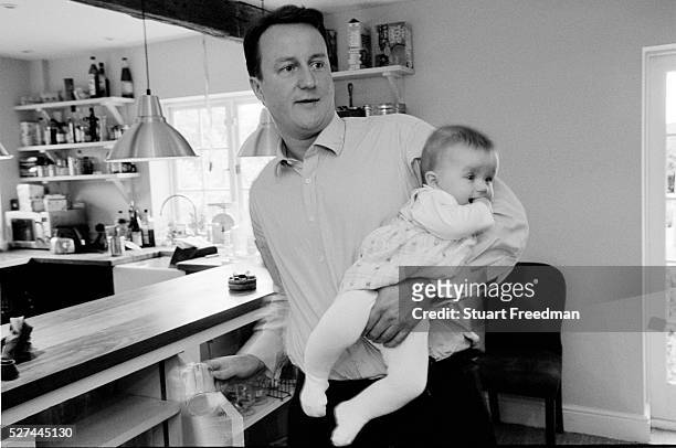 David Cameron, Conservative Party Leader and Conservative MP for Whitney, Oxfordshire, UK at home with his youngest child Arthur