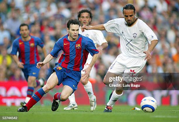 Andres Iniesta of FC Barcelona and Carles Mingo of Albacete in action during the La Liga match between FC Barcelona and Albacete on May 1, 2005 at...