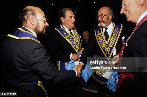Freemasons greet each other by handshakes at an event at Earls Court in London to promote their craft and public understanding. Freemasonry, which...