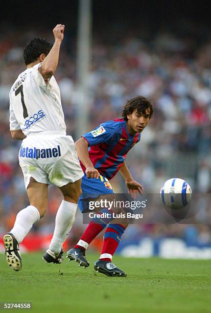 Gio van Bronckhorst of FC Barcelona and Francisco of Albacete in action during the La Liga match between FC Barcelona and Albacete on May 1, 2005 at...