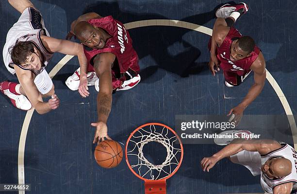 Shaquille O'Neal of the Miami Heat grabs a rebound from Nenad Krstic of the New Jersey Nets as Eddie Jones of the Heat and Richard Jefferson of the...