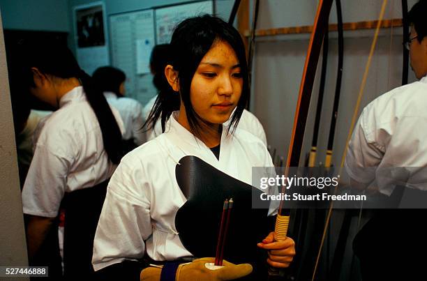 Student at a Kyudo dojo. Kyudo is a modern Japanese martial art derived from ancient Samurai archery and heavily influenced by Zen Buddhist...