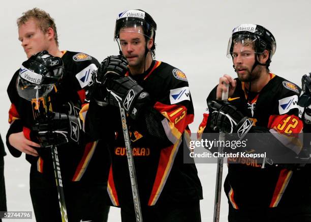 Daniel Kreutzer, Tino Boos and Tomas Martinec of Germany stand dejected after losing to Kazakhstan in the IIHF World Men's Championships preliminary...